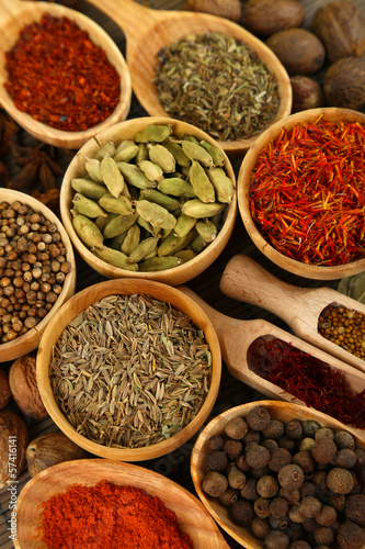 Photo: Many different spices and fragrant herbs close-up background Many different spices and fragrant herbs close-up background