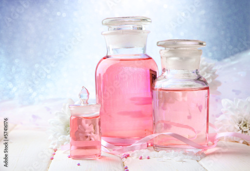 Photo: Glass bottles with color essence, on blue background Glass bottles with color essence, on blue background