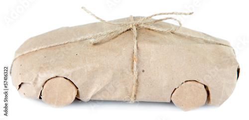 Photo: Car wrapped in brown kraft paper, isolated on white Car wrapped in brown kraft paper, isolated on white