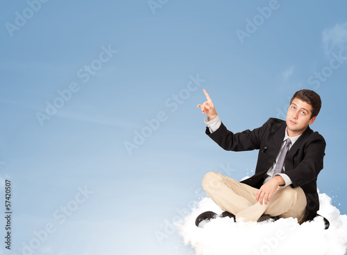 Photo: Attractive businessman sitting on cloud with copy space Attractive businessman sitting on cloud with copy space