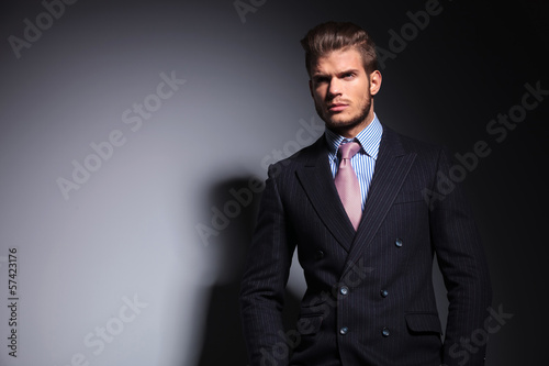 Photo: business man with his hands in pockets is looking away business man with his hands in pockets is looking away