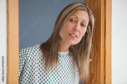 Photo: Female patient looking through doorway Female patient looking through doorway