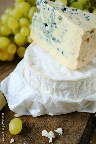 Photo: blue cheese and camembert on a background of grape blue cheese and camembert on a background of grape