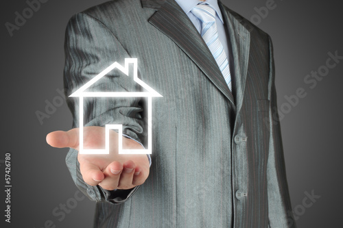 Photo: Virtual house with man on dark background . Virtual house with man on dark background .