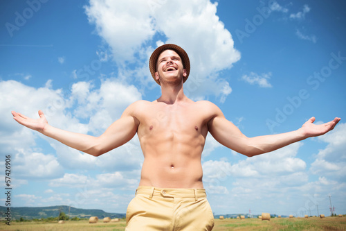 Photo: topless man laughing outdoor with arms wide open topless man laughing outdoor with arms wide open