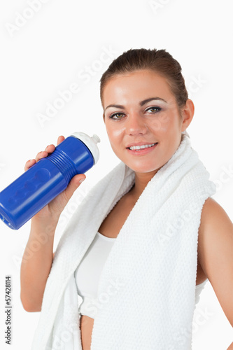 Photo: Smiling woman with her bottle after workout Smiling woman with her bottle after workout