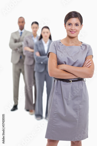 Photo: Woman smiling with her business team crossing their arms Woman smiling with her business team crossing their arms
