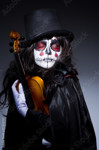Photo: Monster playing violin in dark room Monster playing violin in dark room