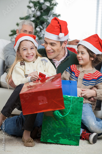 Photo: Siblings And Father With Christmas Presents Siblings And Father With Christmas Presents