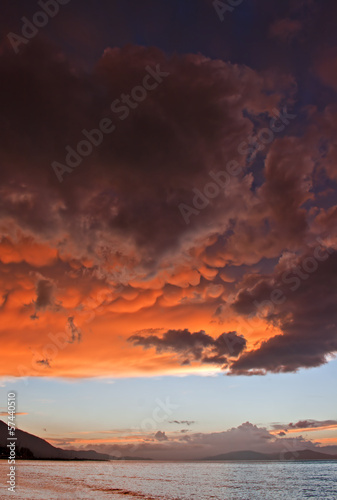 Photo: Mammatus clouds at sunset ahead of violent thunderstorm Mammatus clouds at sunset ahead of violent thunderstorm