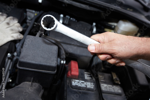 Photo: Hands of auto mechanic with wrench. Hands of auto mechanic with wrench.