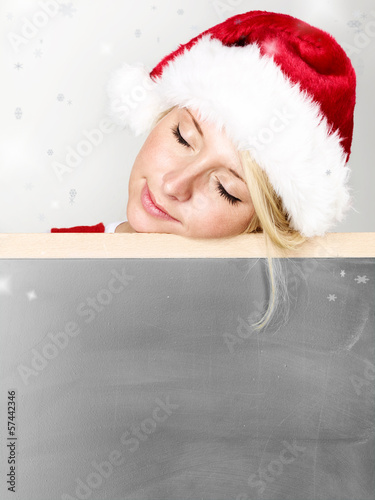 Photo: Women with santa hat sleeping on message board Women with santa hat sleeping on message board