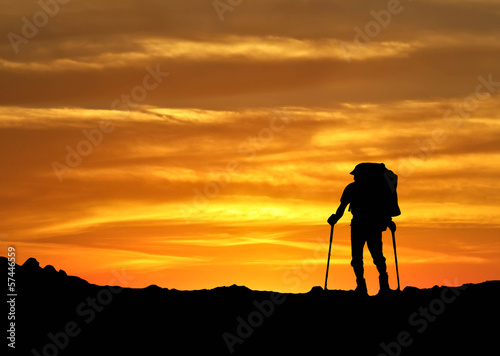 Photo: Silhouette of a winner on the mountain top Silhouette of a winner on the mountain top