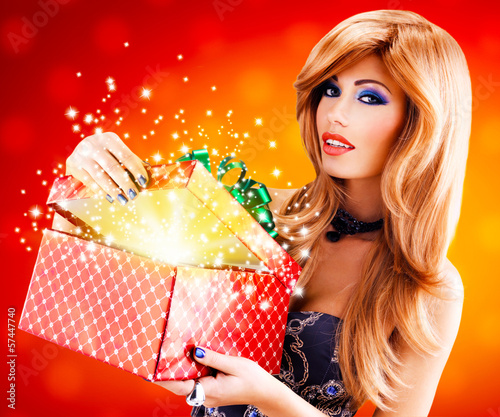 Photo: Beautiful sexy woman with a christmas gift Beautiful sexy woman with a christmas gift