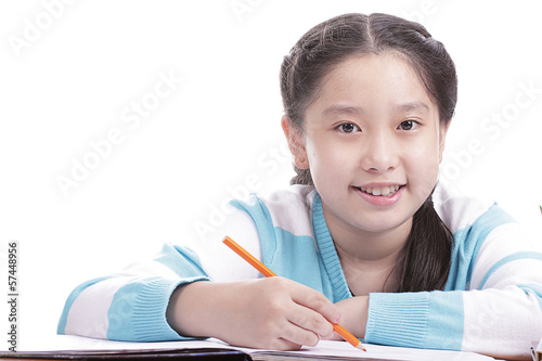Photo: Student girl doing homework Student girl doing homework