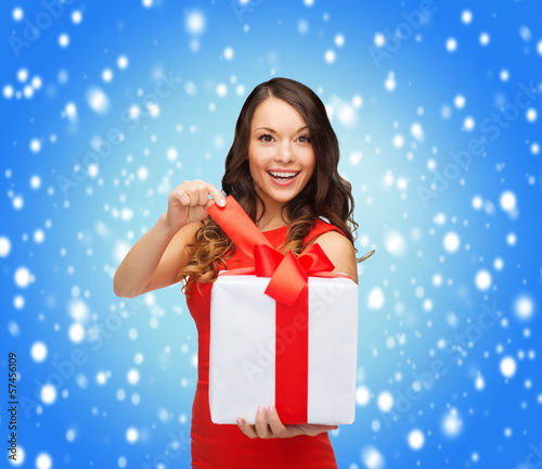 Photo: smiling woman in red dress with gift box smiling woman in red dress with gift box
