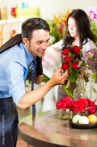 Photo: Saleswoman and customer in flower shop Saleswoman and customer in flower shop