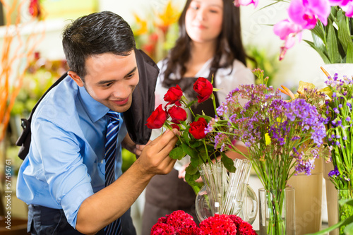 Photo: Saleswoman and customer in flower shop Saleswoman and customer in flower shop