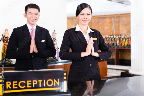 Photo: Chinese Asian reception team at hotel front desk Chinese Asian reception team at hotel front desk