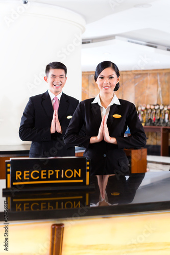 Photo: Chinese Asian reception team at hotel front desk Chinese Asian reception team at hotel front desk