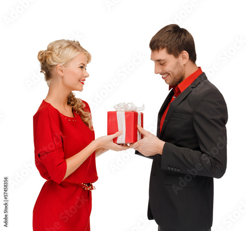 Photo: smiling woman and man with gift box smiling woman and man with gift box