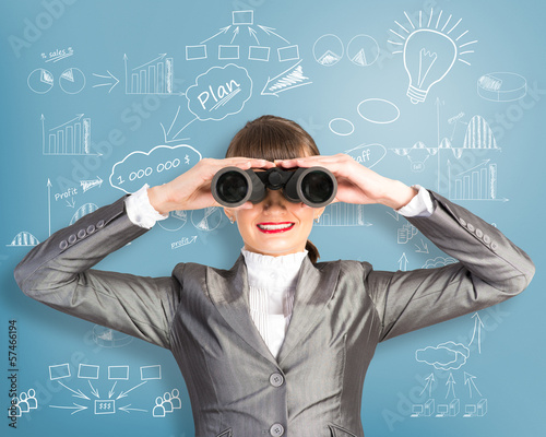 Photo: business woman looking through binoculars business woman looking through binoculars