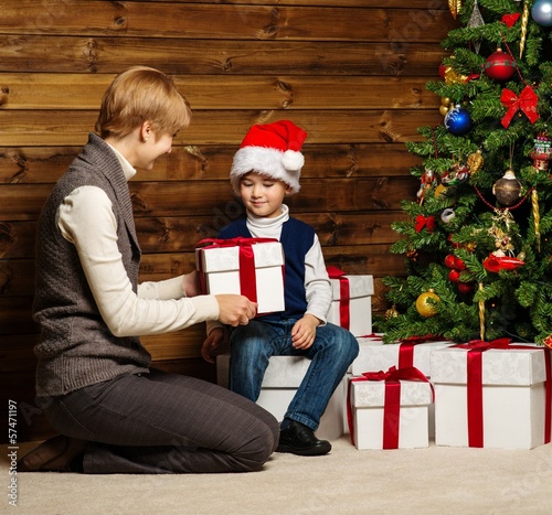 Photo: Mother and her lIttle boy in Santa hat Mother and her lIttle boy in Santa hat