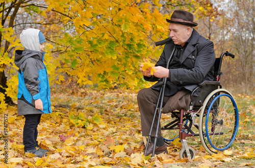 Photo: Young boy with his handicapped grandfather Young boy with his handicapped grandfather