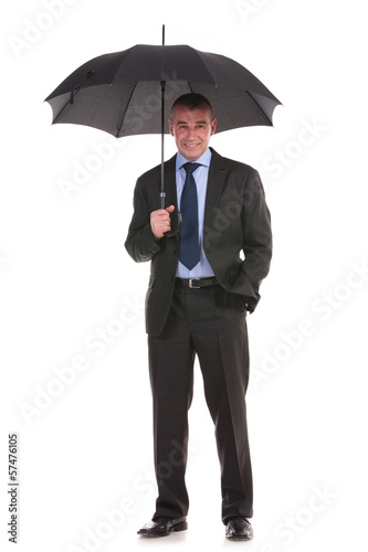 Photo: business man holds his umbrella business man holds his umbrella