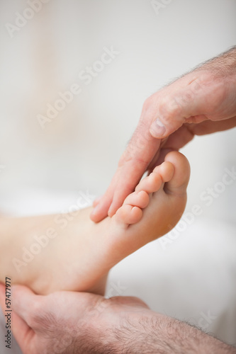 Photo: Physiotherapist offering a foot massage Physiotherapist offering a foot massage