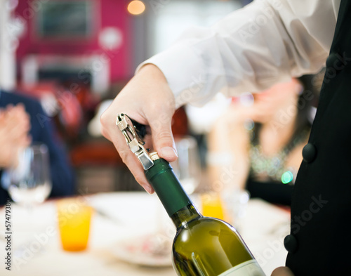 Photo: Waiter uncorking wine Waiter uncorking wine