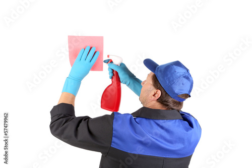 Photo: Man holds spray bottle and sponge. Man holds spray bottle and sponge.