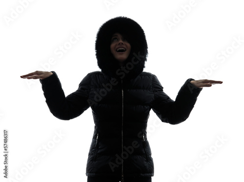 Photo: woman winter coat arms outstretched happy silhouette woman winter coat arms outstretched happy silhouette