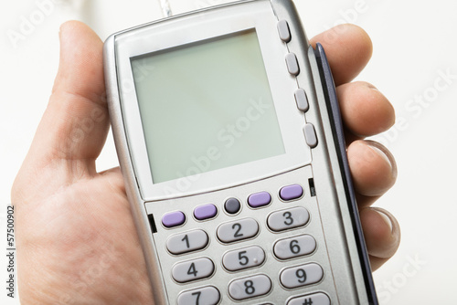 Photo: The modern bank terminal in a man's hand The modern bank terminal in a man's hand