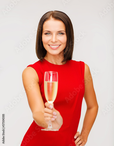 Photo: woman in red dress with a glass of champagne woman in red dress with a glass of champagne