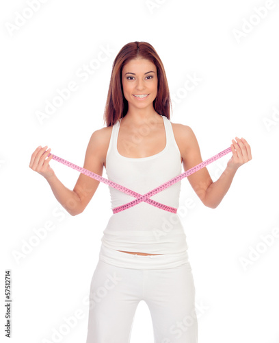 Photo: Attractive happy girl with a tape measure measuring her waist Attractive happy girl with a tape measure measuring her waist