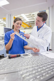 Photo: Scientist and technician examining aluminum products in hi-tech manufacturing plant Scientist and technician examining aluminum products in hi-tech manufacturing plant
