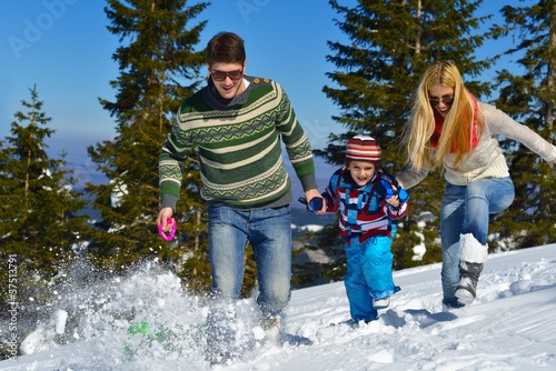 Photo: family having fun on fresh snow at winter family having fun on fresh snow at winter