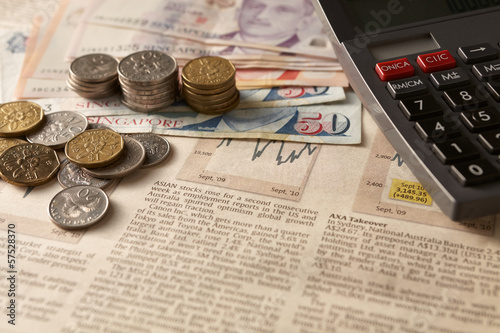 Photo: Newspaper stock market with calculator and money Newspaper stock market with calculator and money