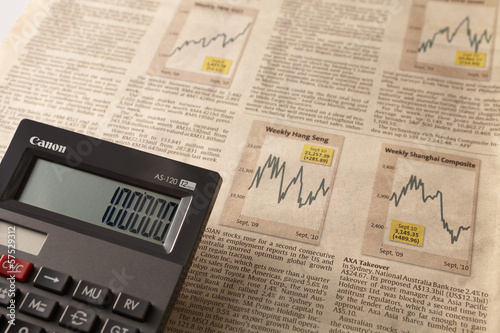 Photo: Newspaper stock market with calculator Newspaper stock market with calculator