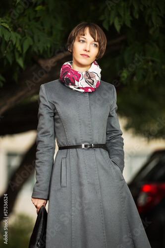 Photo: Young woman in grey classic coat with a handbag Young woman in grey classic coat with a handbag