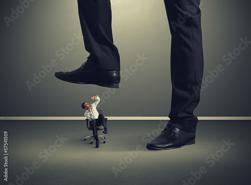 Photo: small man under big leg small man under big leg