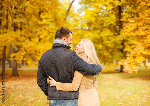 Photo: romantic couple kissing in the autumn park romantic couple kissing in the autumn park