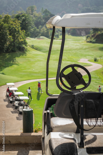 Photo: Golf club cars at golf field Golf club cars at golf field