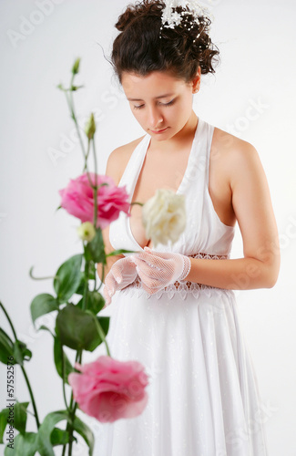Photo: Pretty bride through the flowers blurred Pretty bride through the flowers blurred