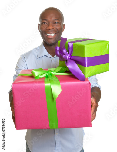 Photo: Laughing african man with two gifts for christmas Laughing african man with two gifts for christmas