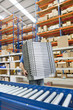 Photo: Portrait of smiling worker holding scanner and boxes at production line in distribution warehouse Portrait of smiling worker holding scanner and boxes at production line in distribution warehouse