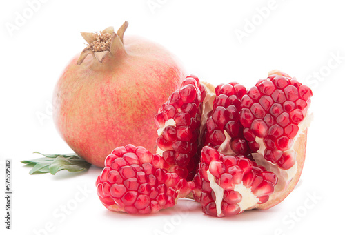 Photo: Ripe pomegranates with leaves isolated on white Ripe pomegranates with leaves isolated on white