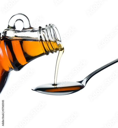 Photo: maple syrup pouring on spoon maple syrup pouring on spoon