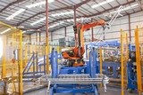 Photo: Robotic machinery lifting steel fencing on production line in manufacturing plant Robotic machinery lifting steel fencing on production line in manufacturing plant